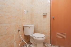 a bathroom with a toilet and a shower at RedDoorz Syariah near Regol Park Bandung in Bandung