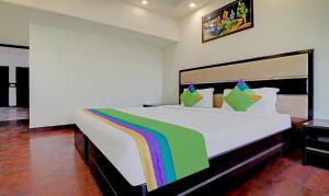 a bedroom with a large white bed with a rainbow at Itsy By Treebo - Southend in Chandīgarh