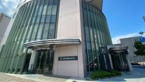 a tall building with a sign on the side of it at Hiroshima Tokyu REI Hotel in Hiroshima