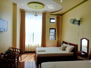 Postel nebo postele na pokoji v ubytování Đức Chính Hotel - Ninh Chu - Phan Rang