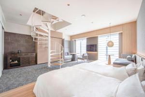 a bedroom with a bed and a spiral staircase at Park Hotel Kyoto in Kyoto
