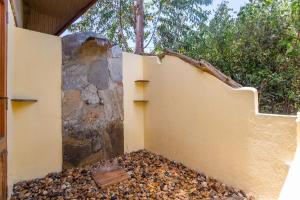 a wall with a pile of rubble next to a rock at PrideInn Mara Camp & Cottages in Talek