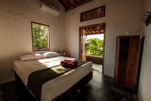 a bedroom with a bed and a window at Nextdoor Homestay in Yogyakarta