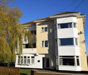 a large apartment building with white at Lovely 2-Bed Apartment Central Skegness Beach in Skegness