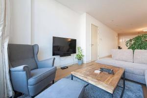 a living room with two chairs and a couch and a table at Luxury Prinsengracht Canal House Jordan Area in Amsterdam