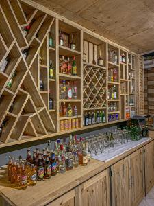 a bar with a lot of bottles and glasses at Panama Garden Resort in Moshi