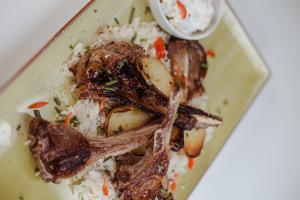a plate of food with meat and rice at Complex Carol in Buzău +25 photos