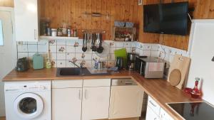 cocina con encimera con fregadero y lavadora en Monteur-, Ferien- und Gästehaus in Groß Rossau, en Osterburg Siedlung