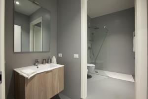 a bathroom with a sink and a toilet and a mirror at Residenza Dante in Nuoro
