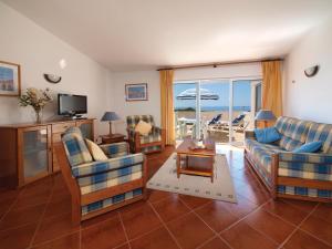 a living room with couches and a view of the ocean at Seaview Apartments in Salema