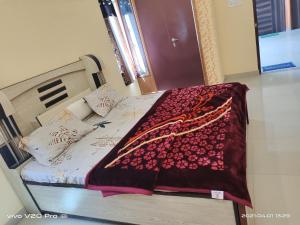 A bed or beds in a room at HOTEL PURNIMA PALACE