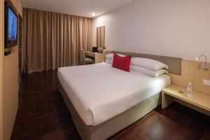 Voodi või voodid majutusasutuse Rocana Hotel toas