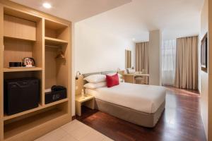 Säng eller sängar i ett rum på Rocana Hotel