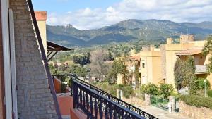 a balcony with a view of a city and mountains at Affittacamere La Suite dei Graniti in Villasimius