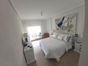 Łóżko lub łóżka w pokoju w obiekcie Apartamento de lujo en La Isla del Fraile