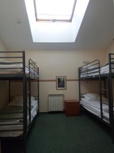 a room with two bunk beds and a skylight at Kurskaya 10 Mini-Hotel in Saint Petersburg