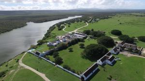 an aerial view of a house next to a river at De Hoop Collection - Equipped Cottages in De Hoop Nature Reserve