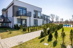 a house with a row of trees in front of it at Apartament Paraiso by Renters in Łukęcin