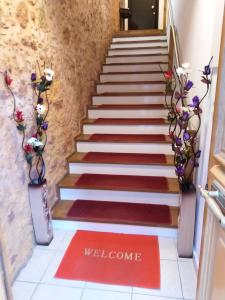 un conjunto de escaleras con alfombra de bienvenida en Santrivani Rooms en La Canea