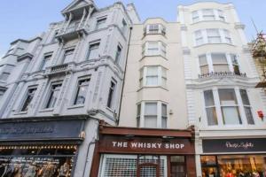 a tall white building with a shop in front of it at CITY HEART BRIGHTON in Brighton & Hove