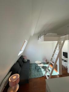 a living room with a couch and a bunk bed at Beautiful Lincoln Apartment in Paris