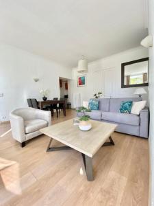 a living room with a blue couch and a table at L'Orient Palace Apartments in Menton