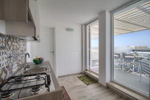 A kitchen or kitchenette at Jacuzzi Holiday Homes by LoveSud