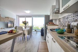 A kitchen or kitchenette at Jacuzzi Holiday Homes by LoveSud