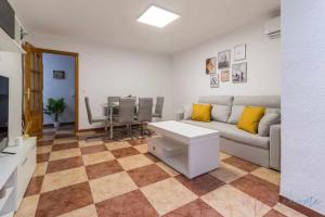 a living room with a couch and a table at Suite con jacuzzi en el centro vistas y garaje in Huelva