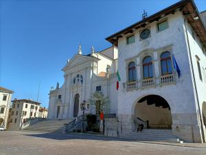 a large white building with a staircase in front of it at Affittacamere CASA DOLCE CASA SAN DANIELE in San Daniele del Friuli