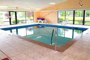 a large swimming pool in a house with a pool at Baymont by Wyndham Springfield in Springfield