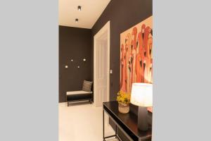 a living room with a large painting on the wall at josef's home I Pink Flamingo I Deluxe Suite in Vienna