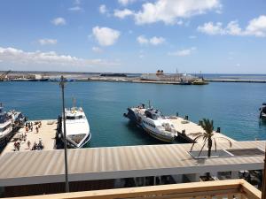 two boats docked at a dock in a harbor at Beb al porto da joseph in Trapani