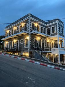 a large white building with lights on a street at יחידת נופש בבית ורדי in Tiberias +6 photos