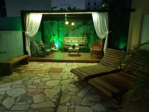 a living room with a couch and a table at Hotel Casarão Pitangueiras in Guarujá