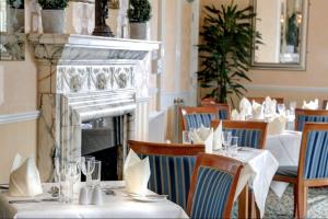 a dining room with tables and chairs and a fireplace at iLodge Ultra in Louth