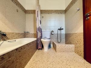 łazienka z toaletą i wanną w obiekcie Archangelos Garden House w mieście Archangelos