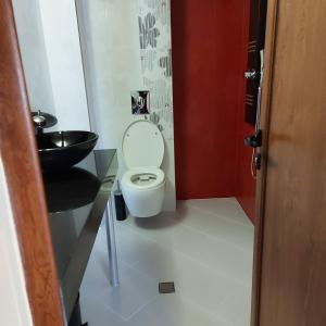 a bathroom with a toilet and a sink at Студио Лидия in Velingrad