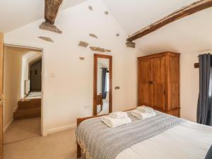 a bedroom with a bed with towels on it at Broadwood Barn in Hathersage