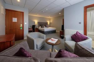 a living room filled with furniture and a couch at The Diplomat Hotel Restaurant & Spa in Llanelli