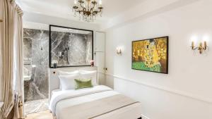 a hotel room with a bed and a chandelier at Luxury 4 bedroom 3 bathroom Aristocratic apartment - Louvre in Paris