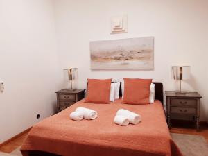 a bedroom with a bed with two towels on it at Villa Zawaia B&B in Lagos