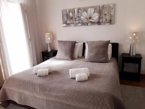 a bedroom with a bed with two towels on it at Villa Zawaia B&B in Lagos