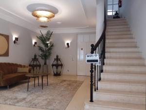 a living room with a sign that reads wifi at Villa Zawaia B&B in Lagos