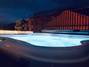 a large hot tub in front of a building at night at Dimora de Matera Luxury Suites in Cosenza