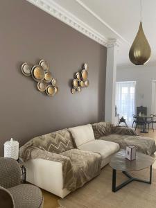 a living room with a couch and bowls on the wall at Villa Zawaia B&B in Lagos