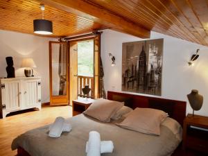 a bedroom with a large bed with white towels on it at Chalet Greystone in Brides-les-Bains
