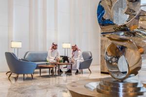 two women sitting at a table in a lobby at Aber Al Yasmin in Riyadh