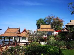 um grupo de casas com telhados de azulejo em Ayutthaya Garden River Home em Ban Bang Krasan