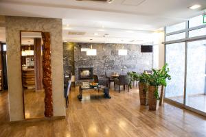 a lobby with a living room and a dining room at Hotel Ring in Orechová Potôň